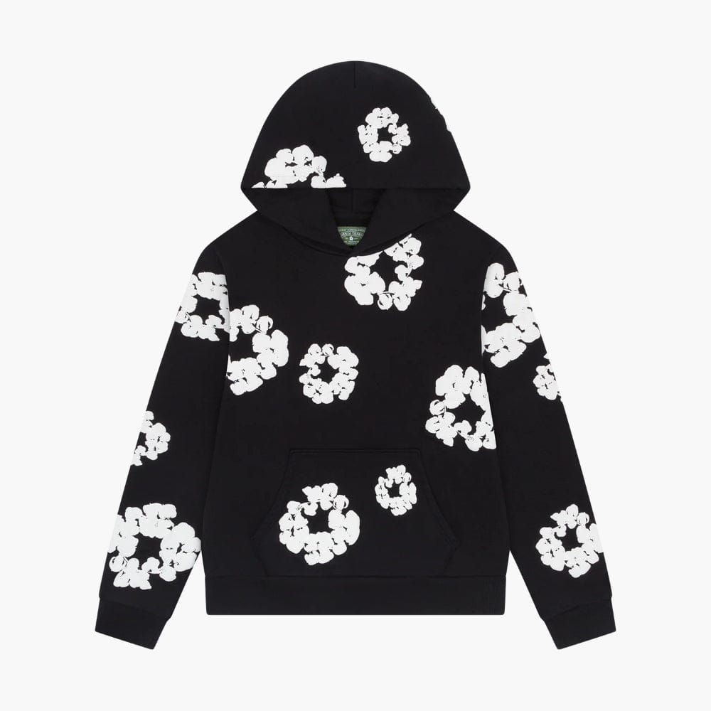 The Black “Cotton Wreath” Denim Tears Hoodie features a front pocket, hood, and white floral ring print—a stylish streetwear piece inspired by the classic Denim Tears aesthetic.