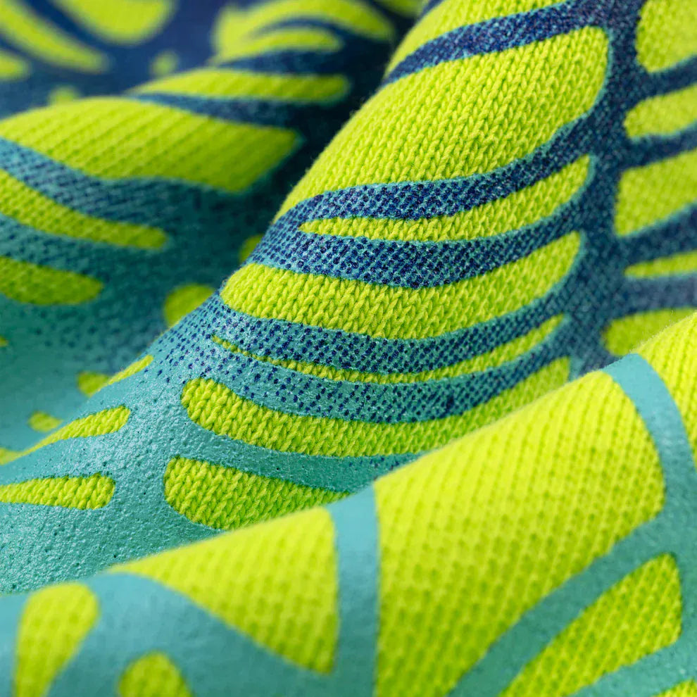 Close-up of the Sp5der Web Graphic Hoodie – Neon Green 440GSM, highlighting its textured heavyweight fabric, vibrant yellow-green background, and bold blue abstract leaf patterns for a standout streetwear look.