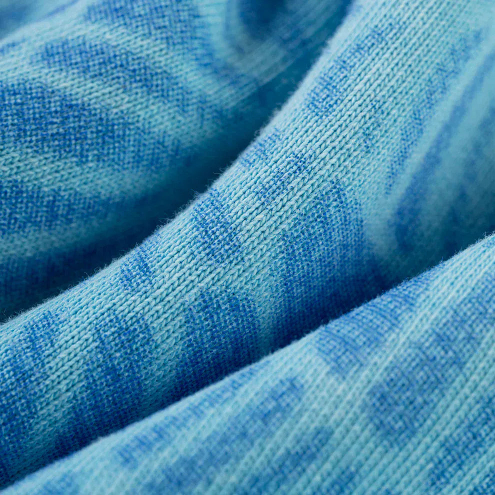 Close-up of heavyweight 440GSM cotton fleece in sky blue fade with a subtle textured pattern—ideal for streetwear like the Sp5der “Blue Venom” Web Hoodie, an oversized pullover perfect for bold style.