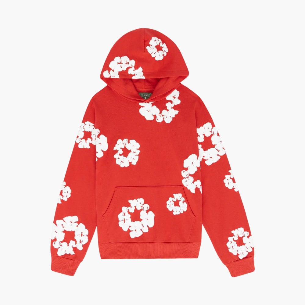 Red “Cotton Wreath” Denim Tears Hoodie—streetwear pullover with front pocket and hood, featuring white floral circle print inspired by cotton wreaths, scattered across the red fabric.