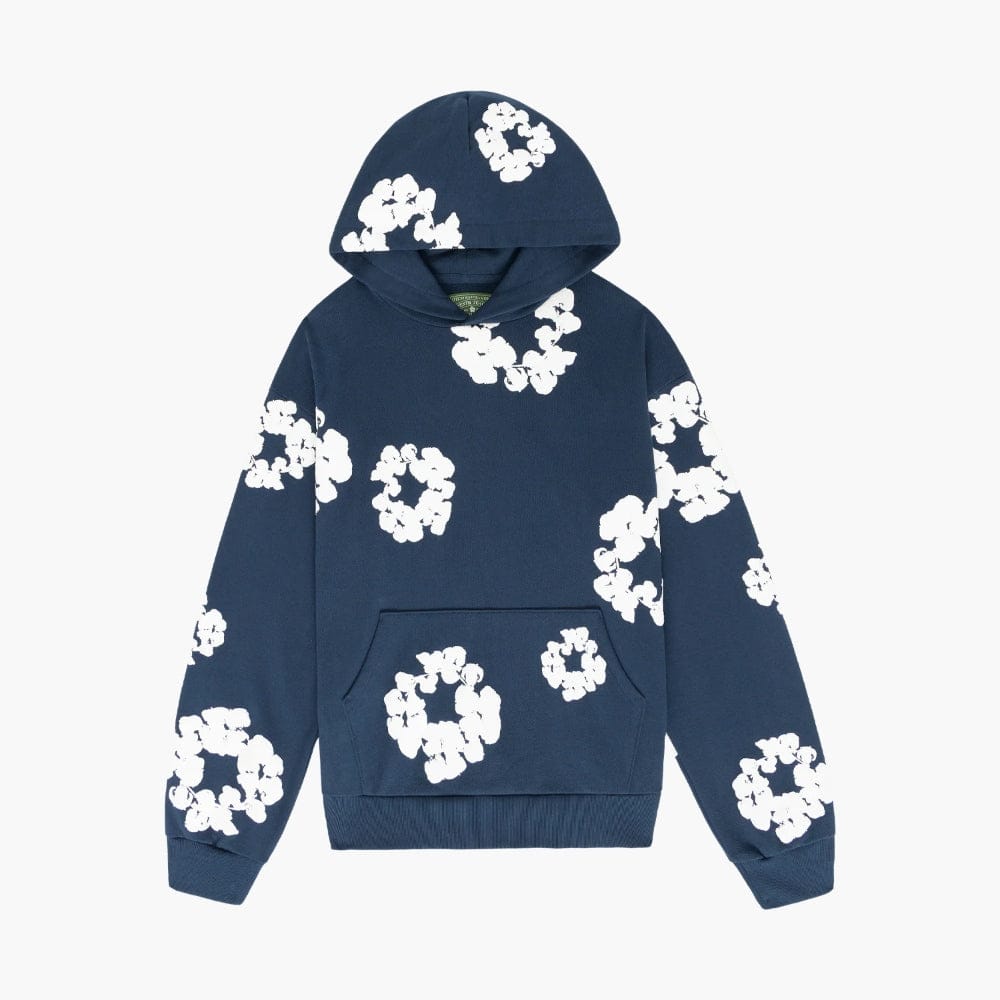The Navy “Cotton Wreath” Denim Tears Hoodie features white floral prints on a navy pullover—an ideal streetwear piece for subtle style.