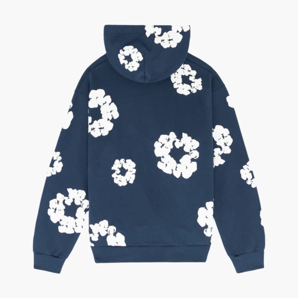 Navy “Cotton Wreath” Denim Tears Hoodie – a streetwear pullover with large white floral prints scattered across the back and sleeves.