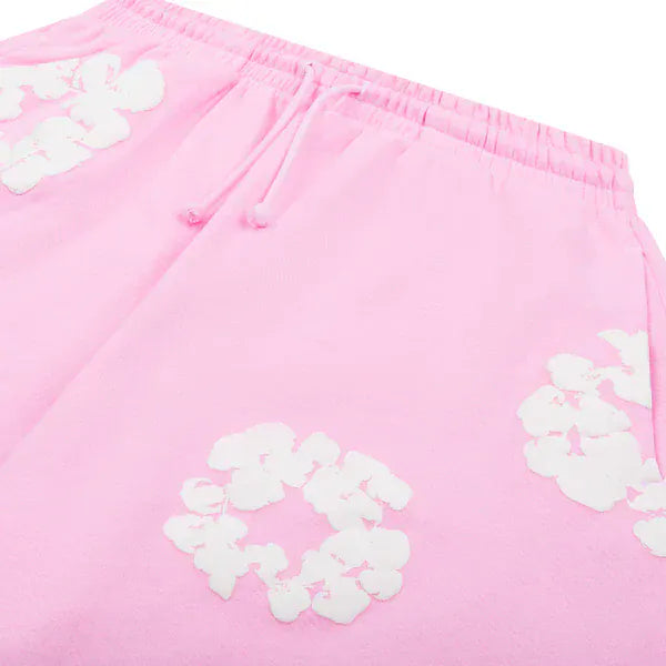 Close-up of Pink “Cotton Wreath” Denim Tears Sweatpants, featuring an elastic waistband, drawstring, and white floral print—unique streetwear style pants.