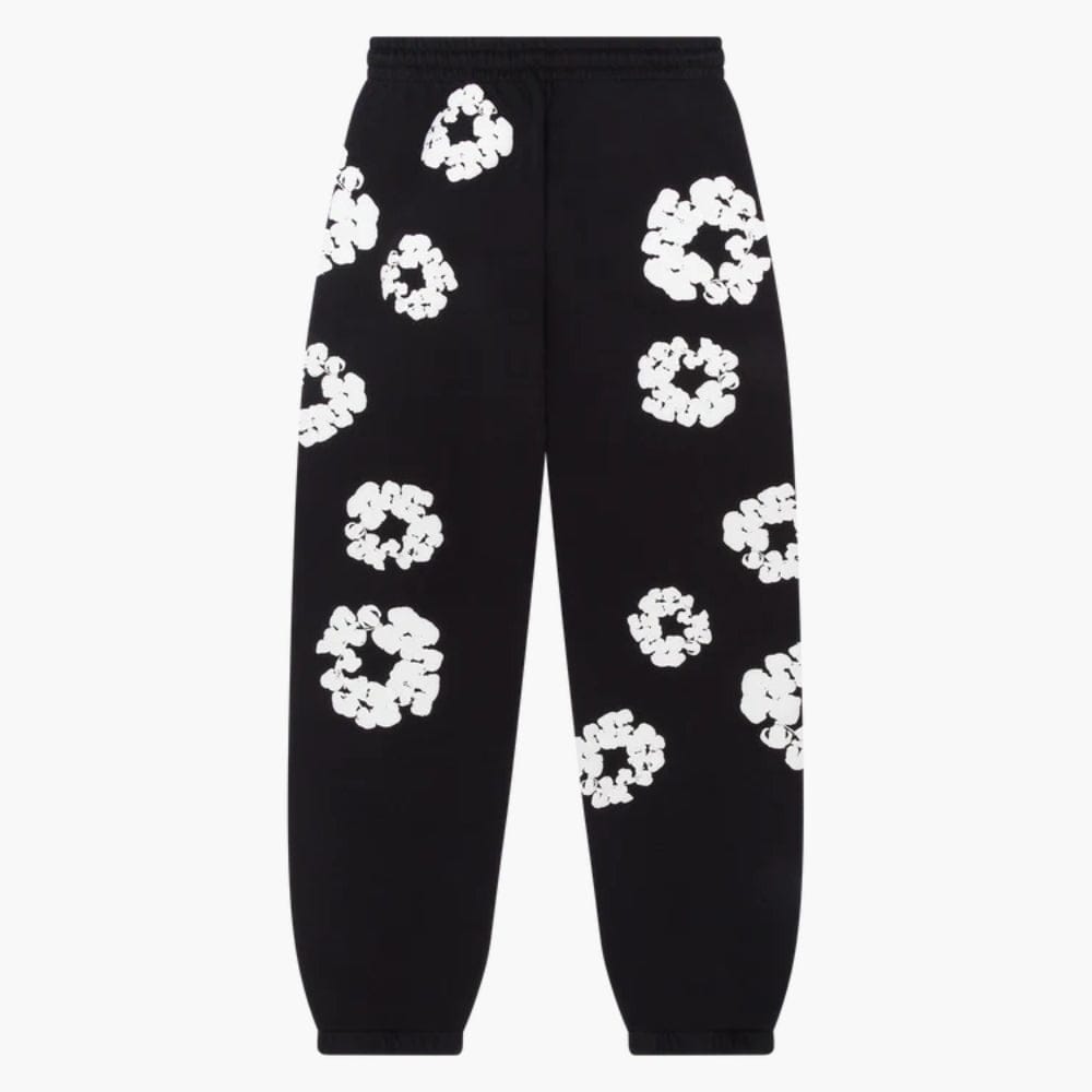 The Black “Cotton Wreath” Denim Tears Sweatpants feature an elastic waistband and cuffs, accented with bold white floral prints inspired by the signature Cotton Wreath motif.