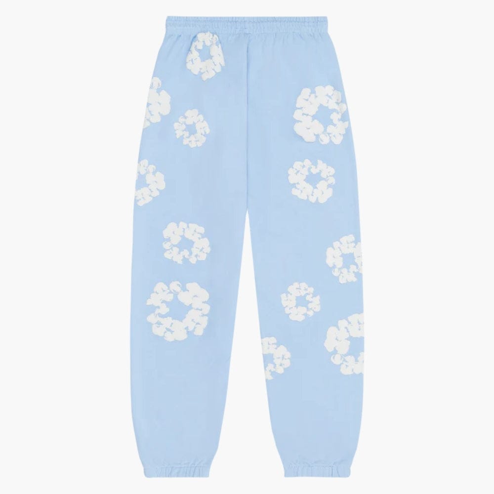 The Light Blue “Cotton Wreath” Denim Tears Sweatpants feature a white floral print, elastic waistband and cuffs—making these streetwear pants an essential addition to any wardrobe.
