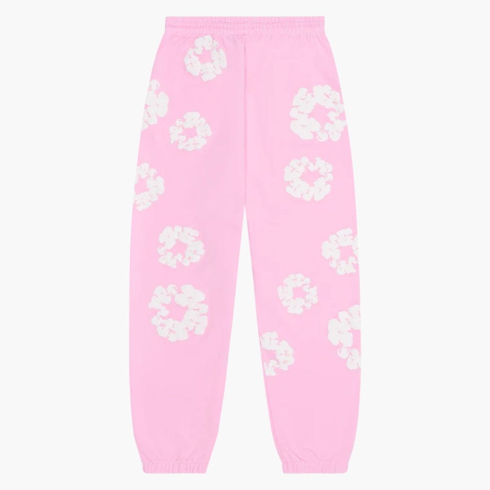 Pink “Cotton Wreath” Denim Tears Sweatpants feature a white floral print on pink streetwear pants, with elastic waistband and cuffs for comfort and bold style.