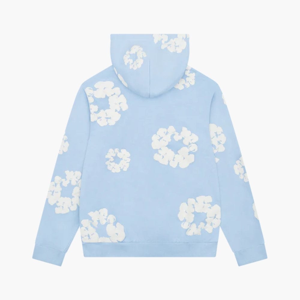 The Light Blue “Cotton Wreath” Denim Tears Hoodie is a streetwear pullover with white floral prints on the back and hood, inspired by the signature Denim Tears style, shown on a plain white background.