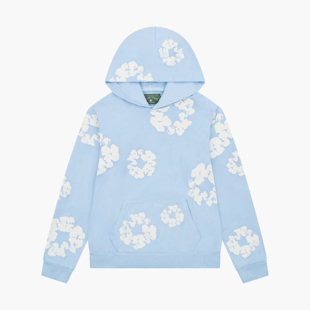Light Blue “Cotton Wreath” Denim Tears Hoodie with white floral print, front pocket, and hood, streetwear pullover laid flat on a plain white background.