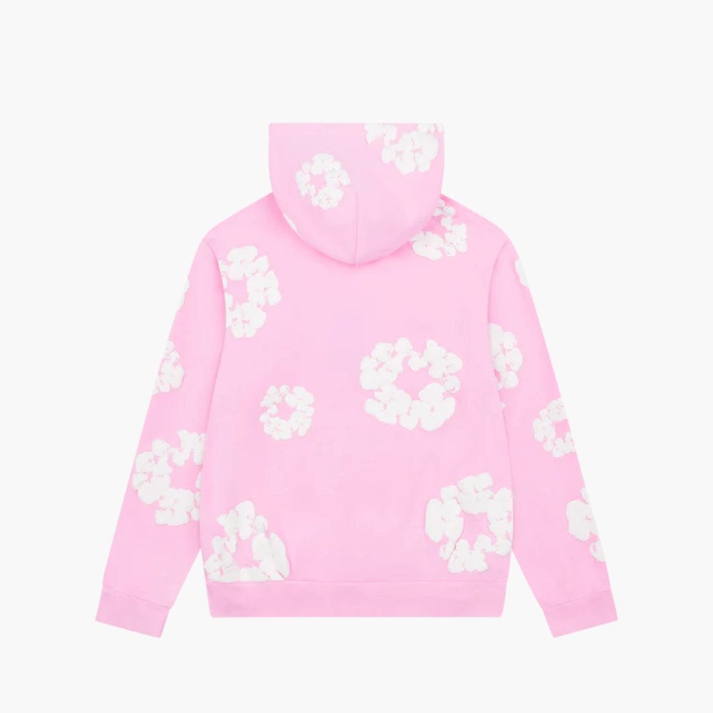 The Pink “Cotton Wreath” Denim Tears Hoodie is a streetwear pullover featuring white floral prints on the back, sleeves, and hood, showcased against a plain white background.