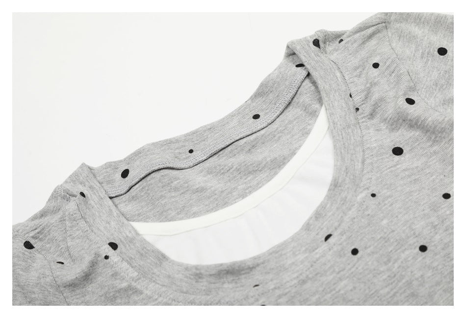 Close-up of the gray dotted T-shirt's round neckline with a white inner layer.