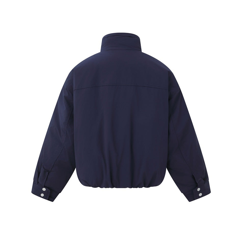 Back view of a navy jacket with a high collar, long sleeves, snap cuffs, and an elasticized hem.