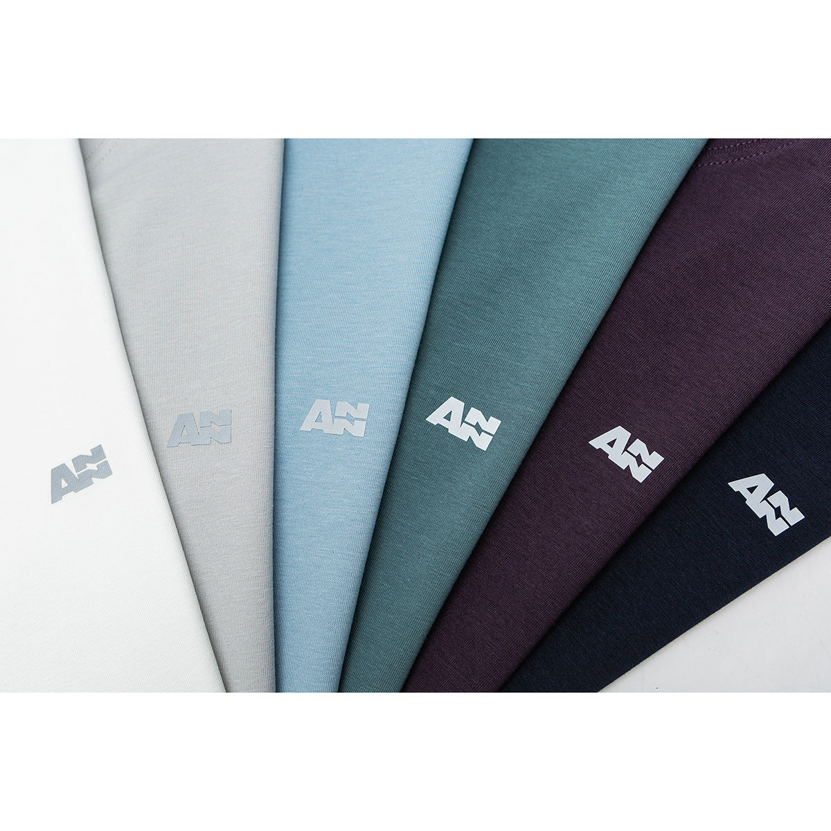 Six fabric colorways arranged in a fan, from white and gray to blue, teal, plum, and navy, each with a small white emblem.