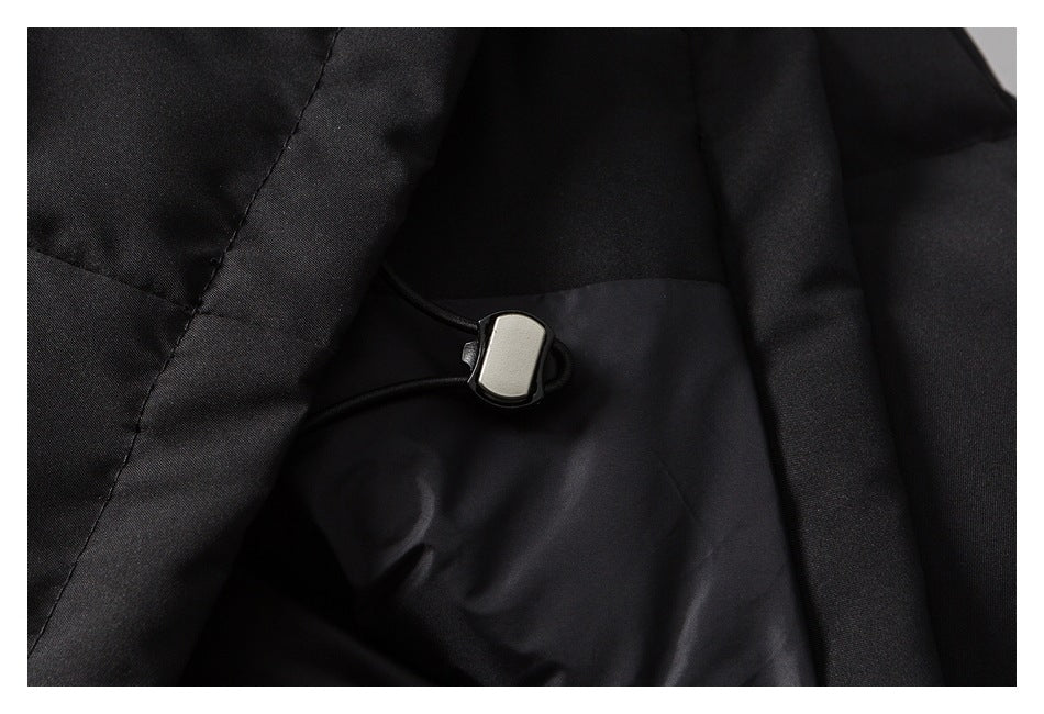 Close-up of the black garment's inner lining and an adjustable drawcord toggle.