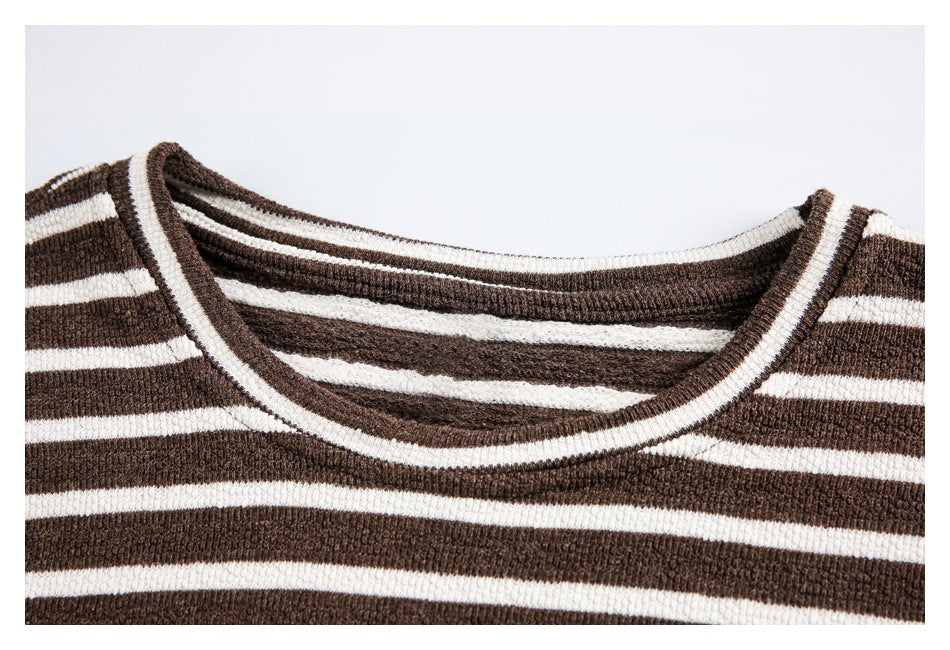 Close-up of a brown-and-cream striped knit top showing its wide ribbed crew neckline.