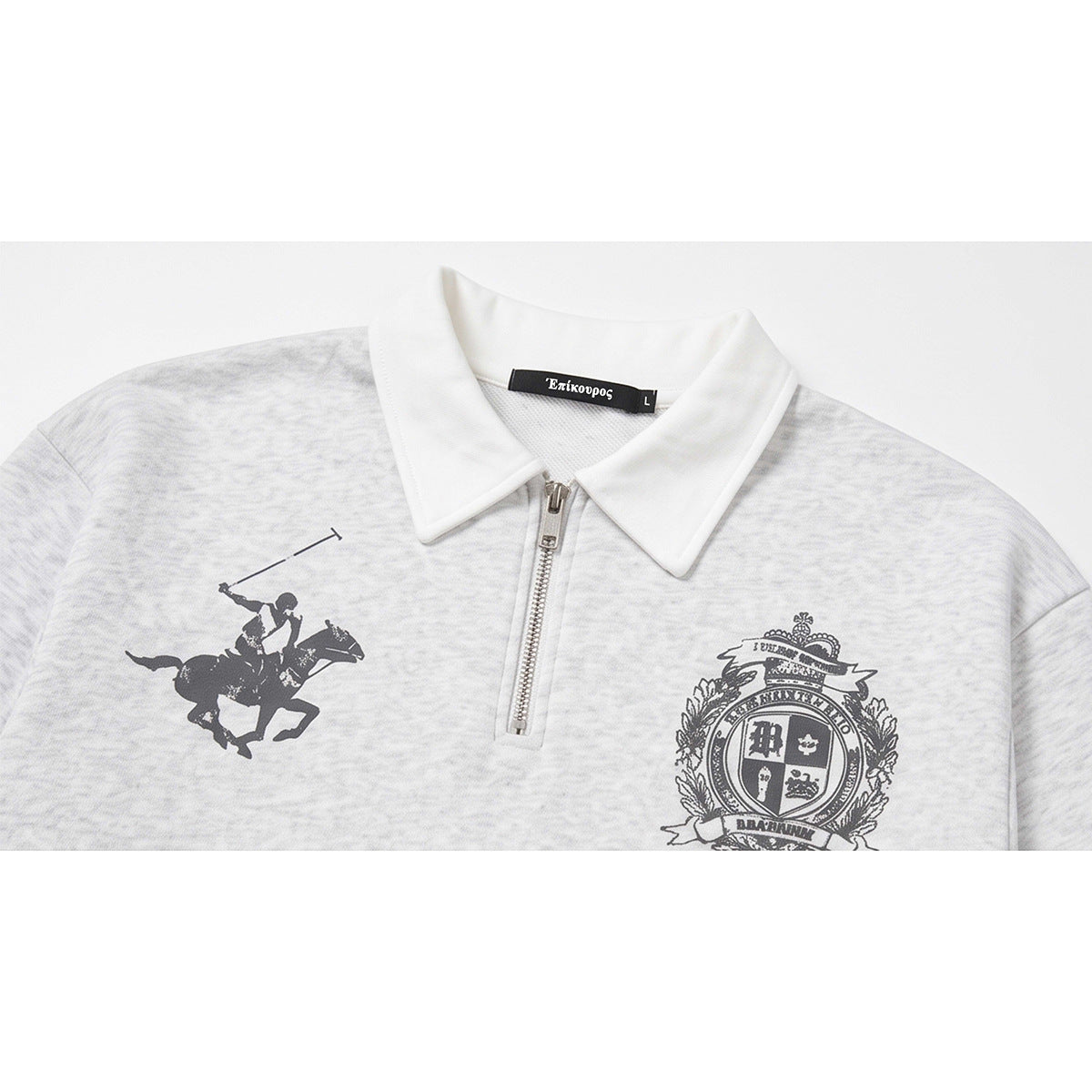 Close-up of a light gray marled sweatshirt with a white collar, short zipper, polo-player graphic, and crest.
