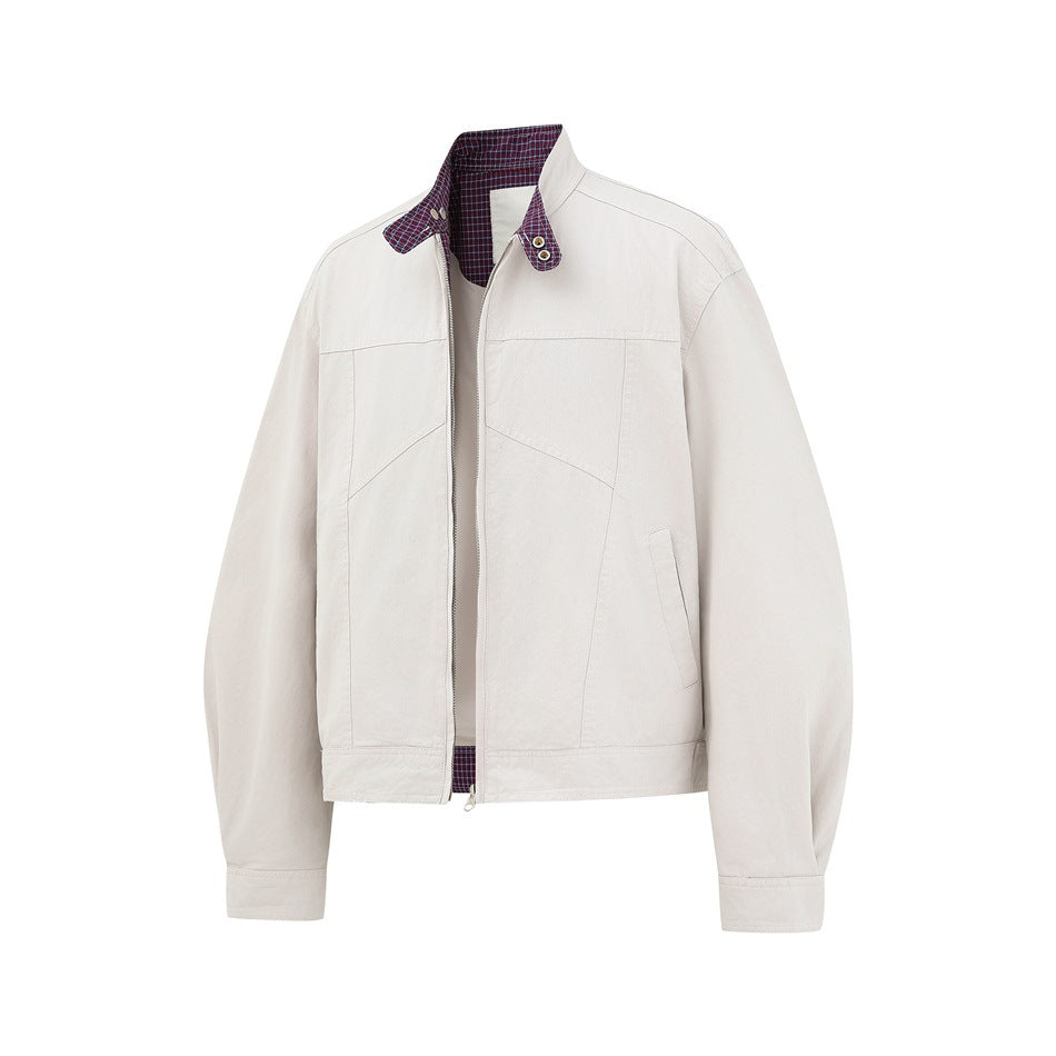 Front view of an ivory zip-front jacket with a plaid-lined stand collar, snap details, and angled pockets.