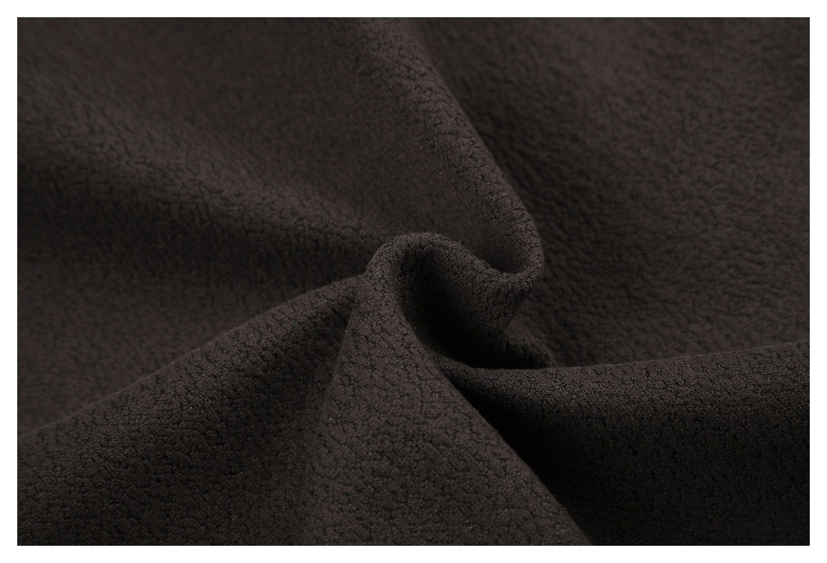 Close-up of dark brown, softly textured fabric gathered into a central fold.