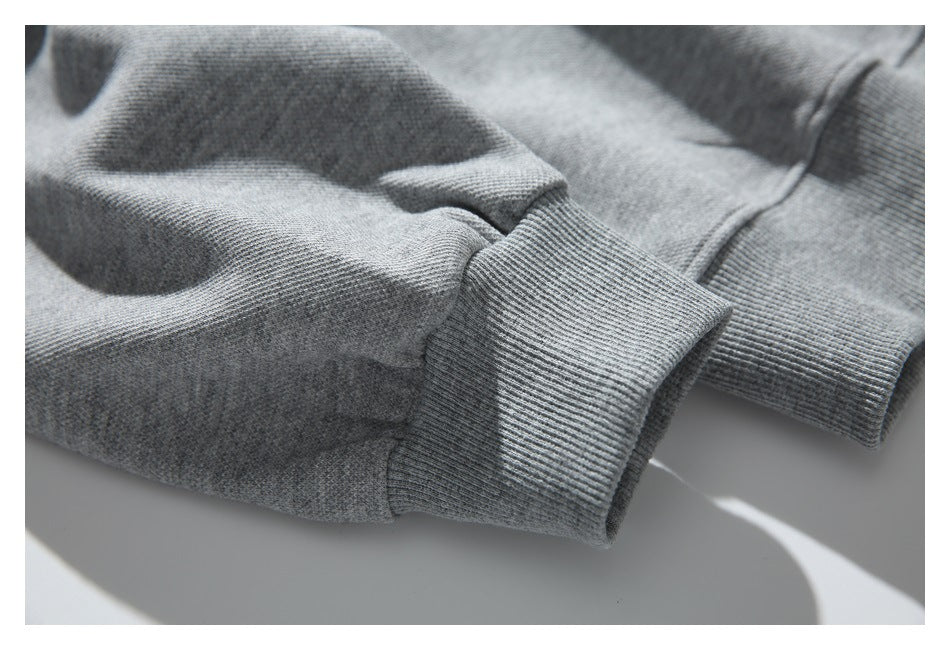 Close-up of a gray sweatshirt sleeve with a wide ribbed cuff.