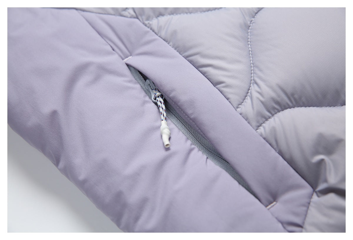 Close-up of a lavender quilted garment with a diagonal zipper and cord pull.