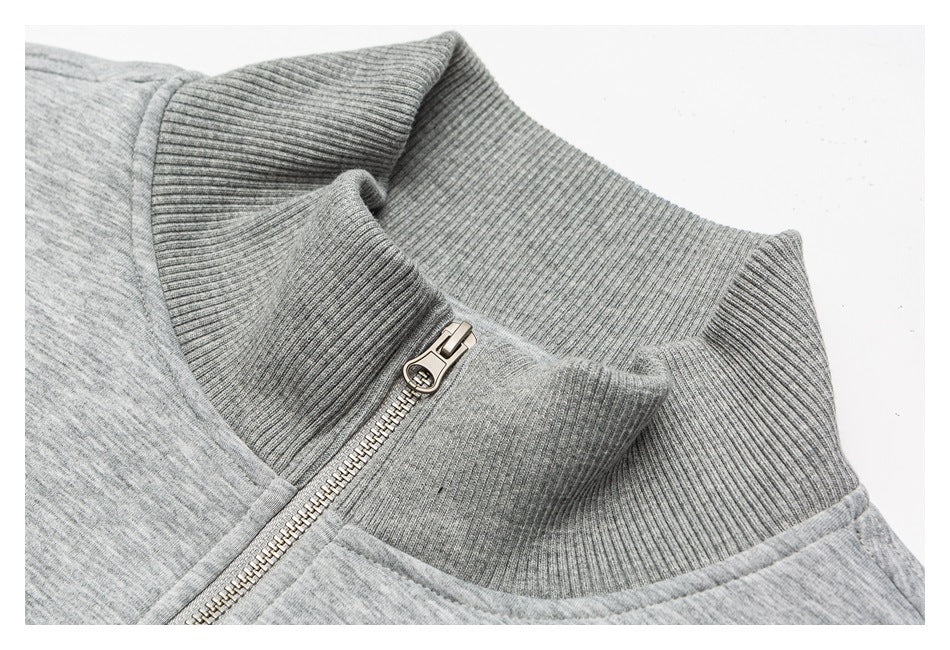 Close-up of a gray ribbed stand collar and metal zipper on a heather-gray garment.