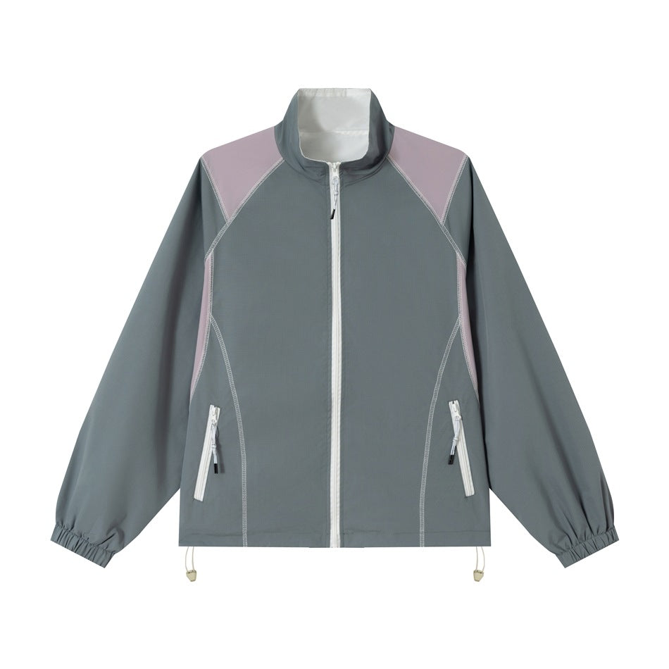 Gray-blue zip-front stand-collar jacket with mauve shoulder and side panels, white zips and contrast stitching