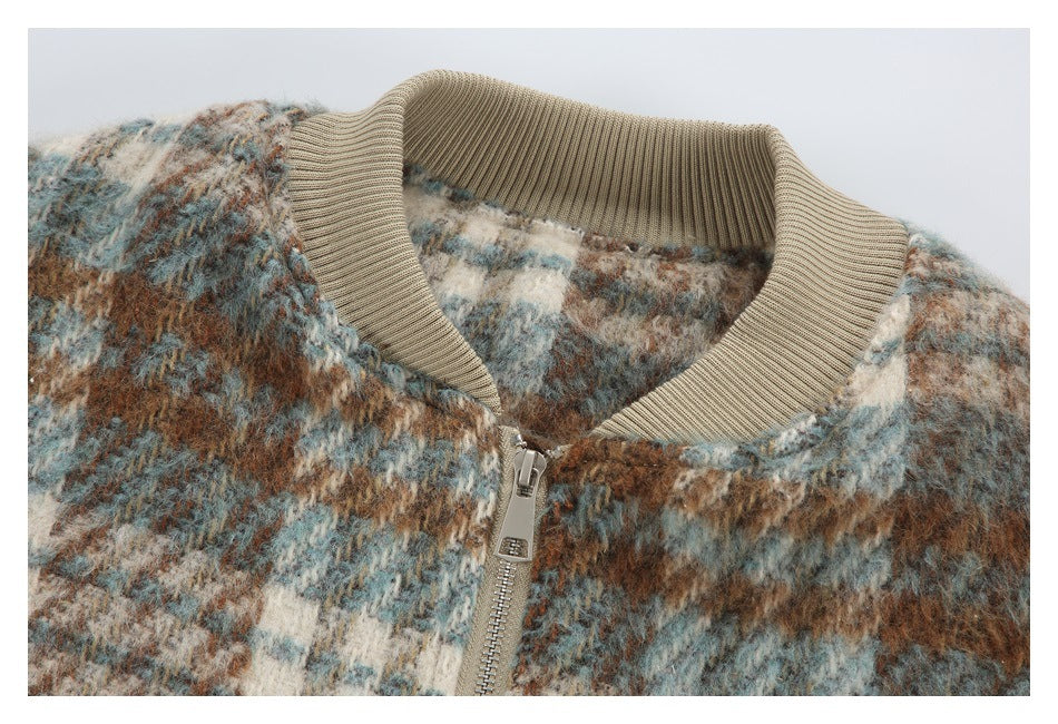 Close-up of a multicolor fuzzy check jacket with a beige ribbed collar and front zipper.
