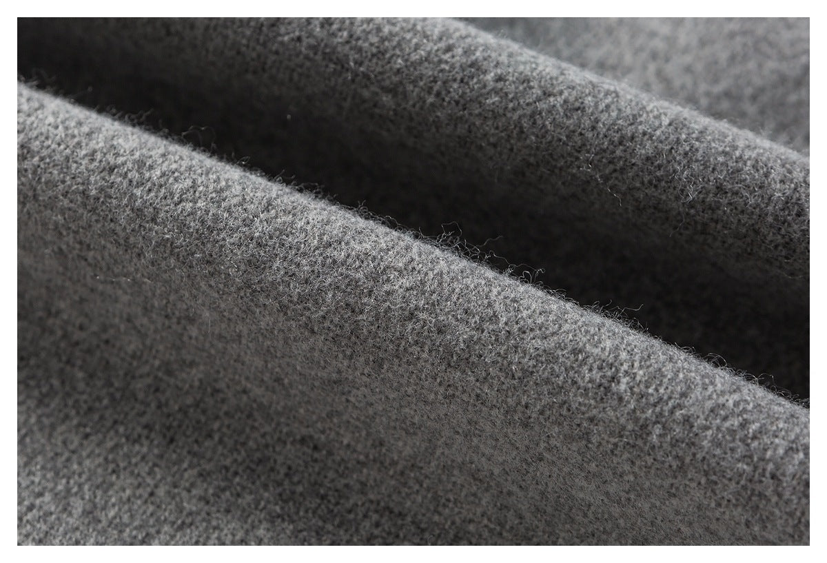 Macro close-up of fuzzy gray fabric folded into ridges, showing its textured surface.