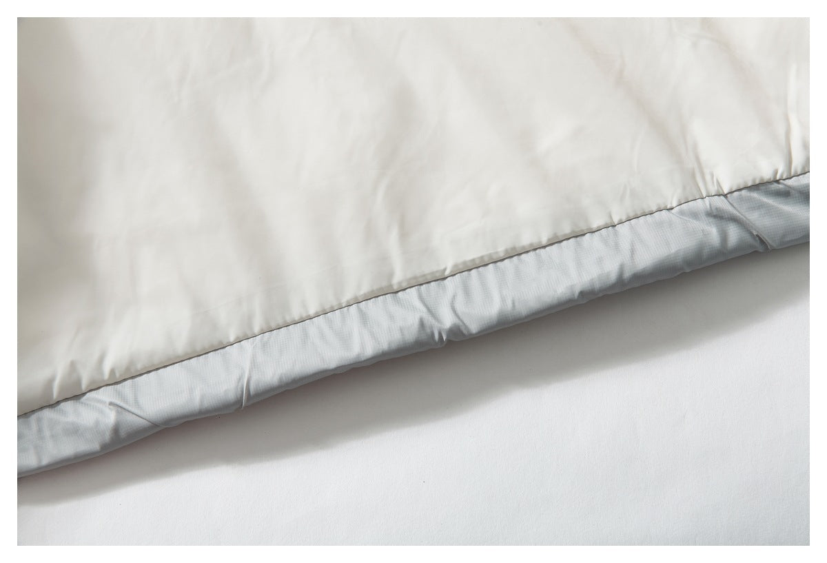 Close-up of the jacket's pale lining and gray outer fabric along the hem.