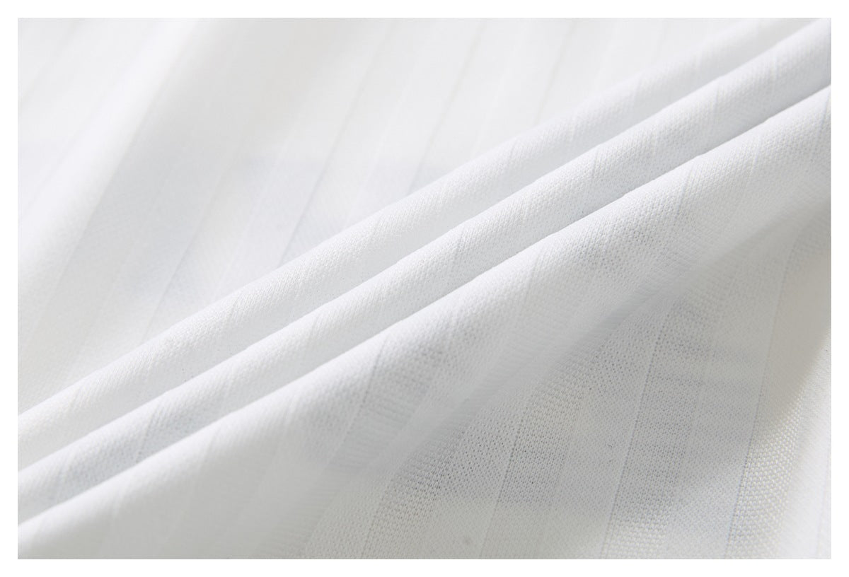 Close-up of white fabric showing its fine textured weave and subtle vertical stripes.