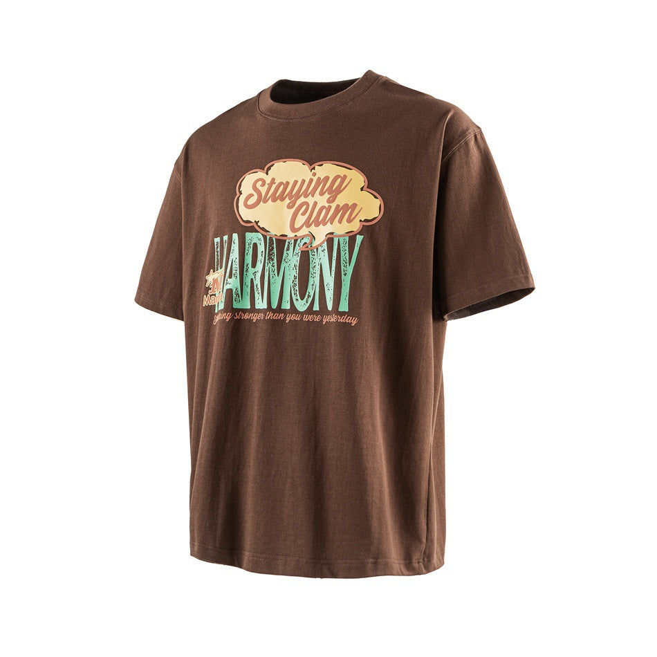Brown short-sleeve crew-neck T-shirt with a colorful “Staying Calm” and “HARMONY” graphic on the front.