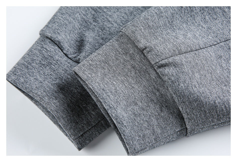 Close-up of overlapping stitched edges on a gray heathered garment.