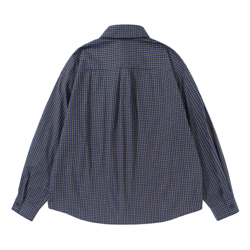 Back view of a long-sleeve navy and brown plaid shirt with a shoulder yoke and center pleat.