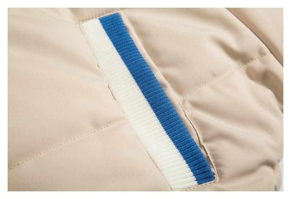 Close-up of a beige jacket panel with a white-and-blue ribbed trim detail and stitching.