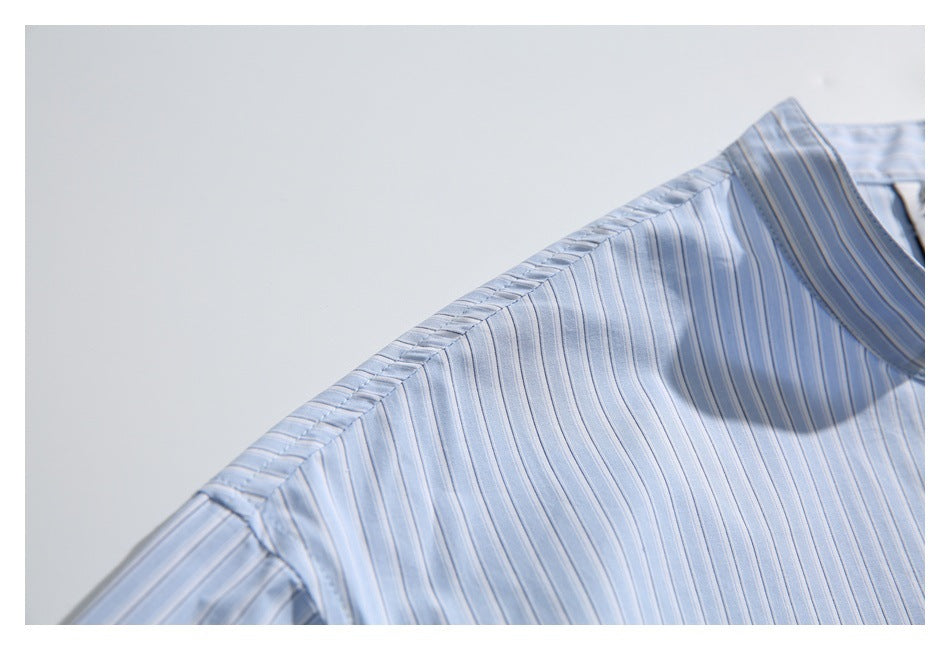 Close-up of the striped shirt’s shoulder seam and collar edge.