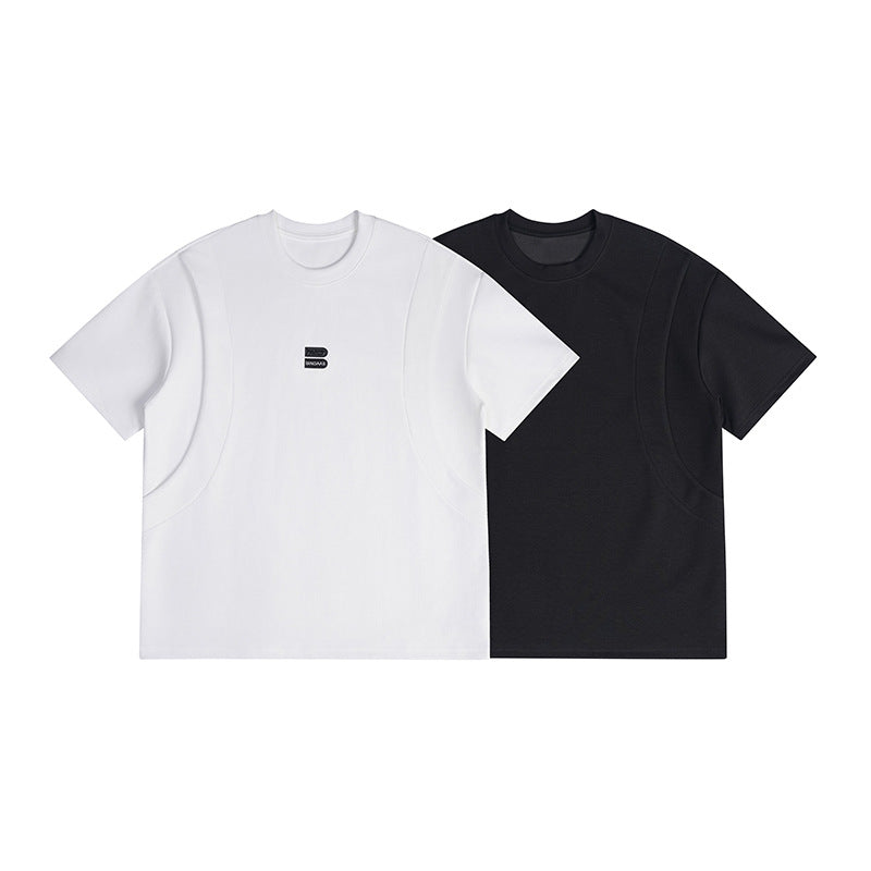 White and black short-sleeve crew-neck T-shirts shown from the front, each with curved seam panels and a small chest logo.