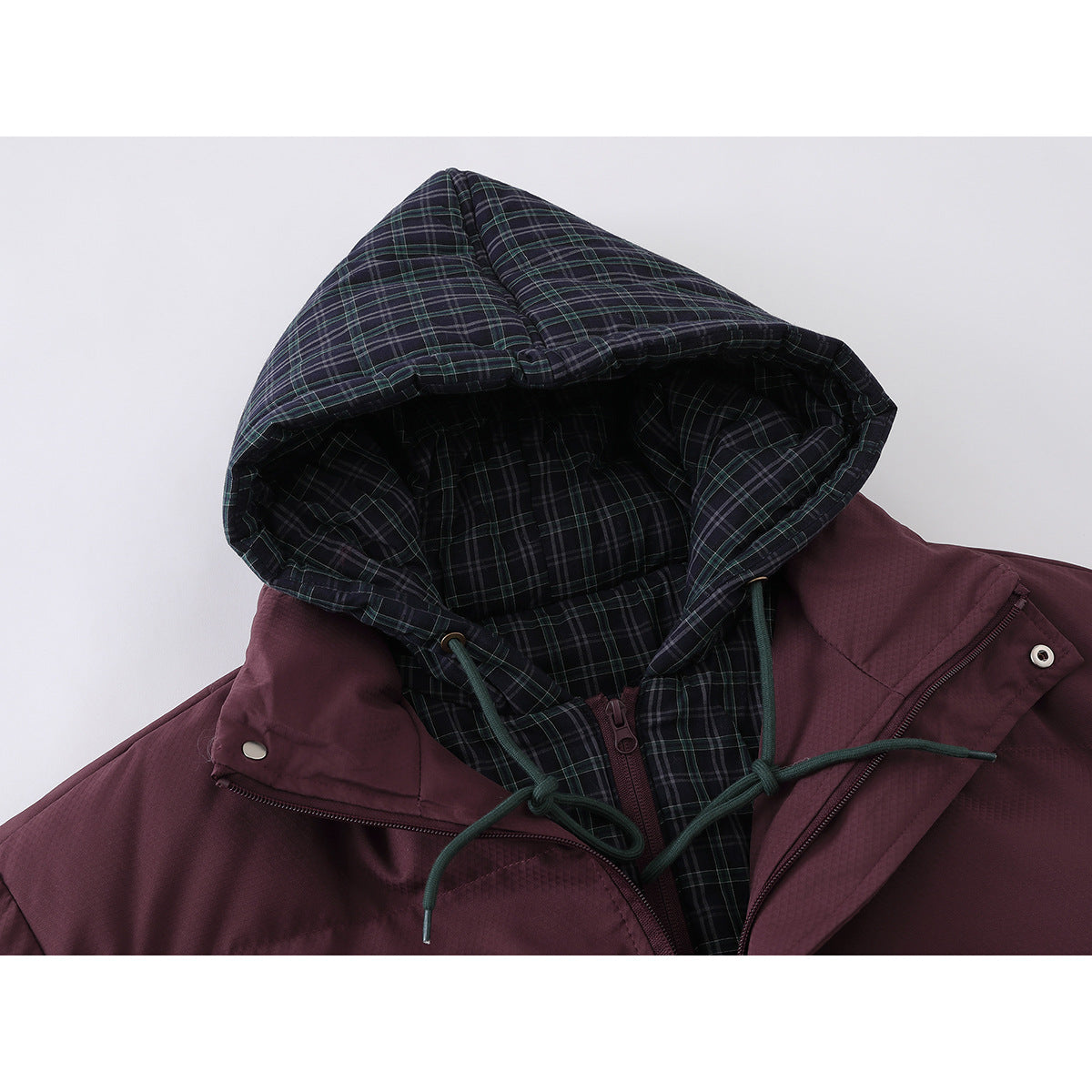 Close-up of a burgundy jacket with a dark green plaid hood lining and green drawstrings.
