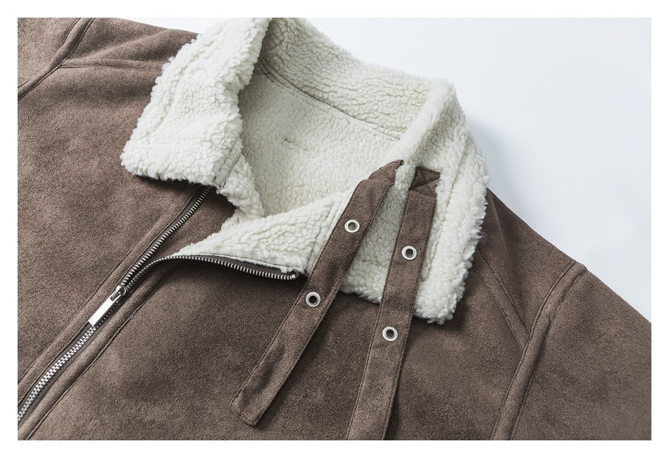 Close-up of the jacket's cream fleece-lined hood and brown snap-fastened straps beside the zipper.