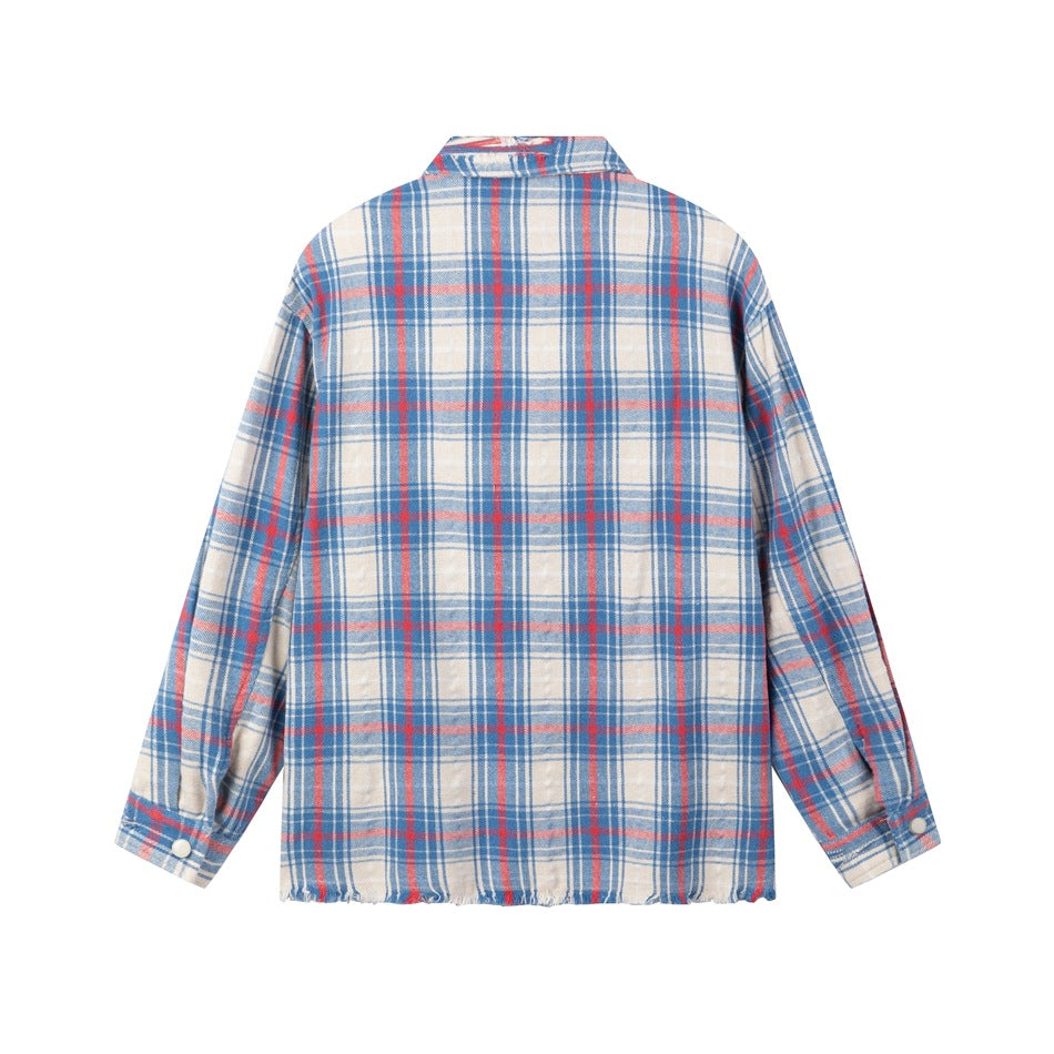 Back view of a blue, red, and cream plaid long-sleeve shirt with snap cuffs and a frayed hem.