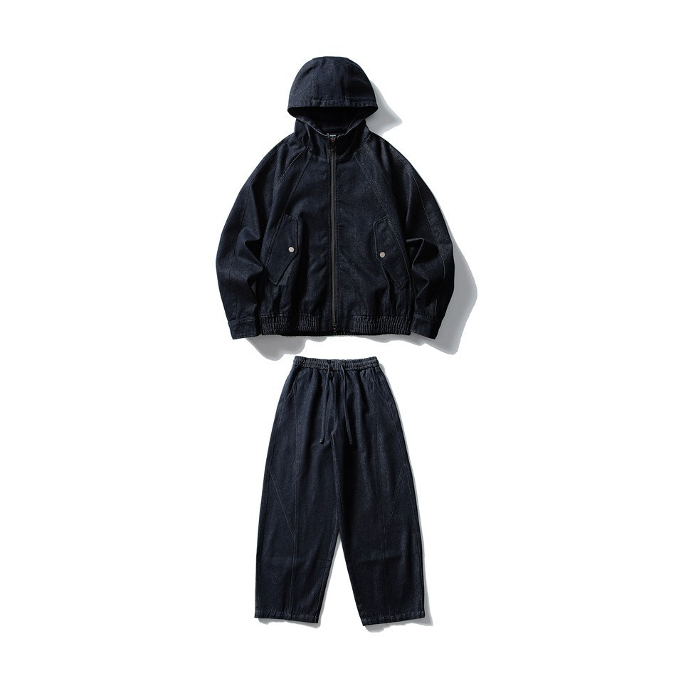 Flat lay of a dark indigo hooded zip jacket with snap-flap pockets and matching drawstring pants.