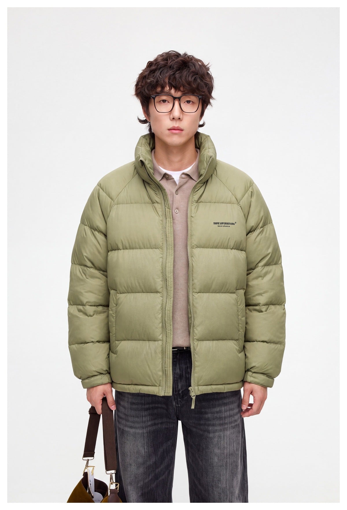 Model wearing a sage-green quilted puffer jacket with a high collar and front zip.