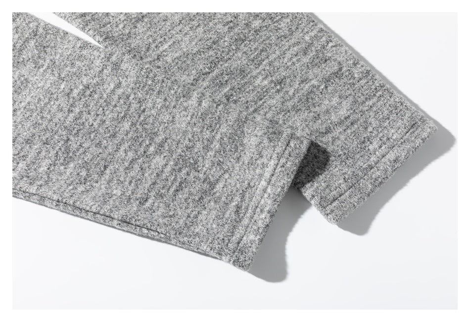 Close-up of a gray marled top's sleeve edge and stitching.