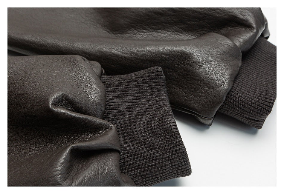 Close-up of dark brown jacket sleeves with wide black ribbed cuffs.