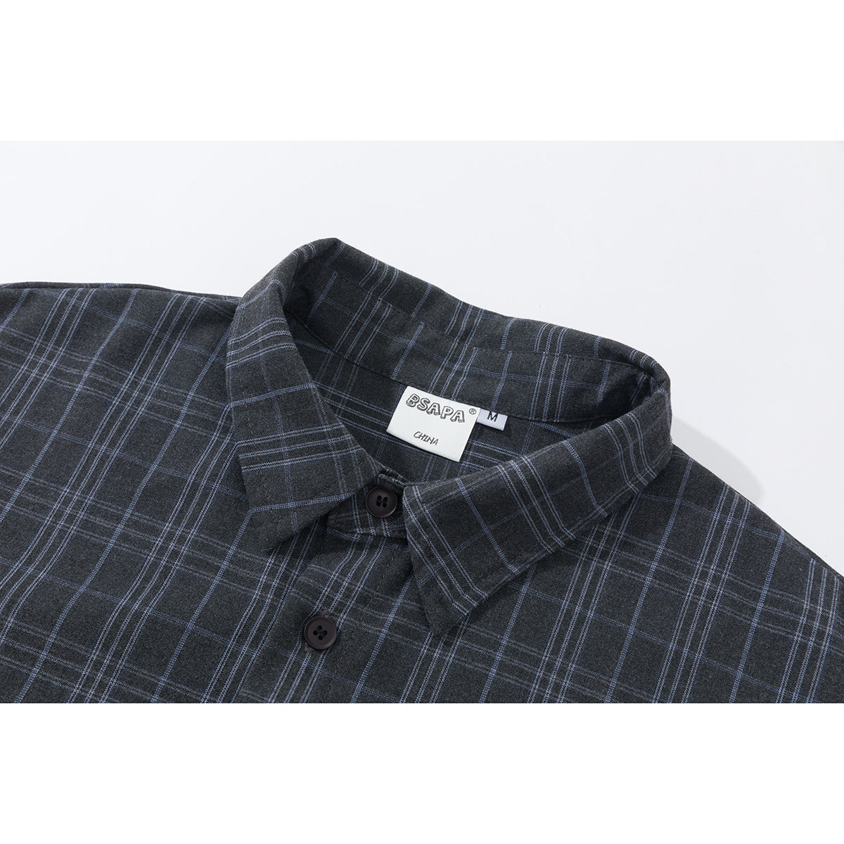 Close-up of a charcoal plaid button-up shirt showing its pointed collar, buttons, and neck label.