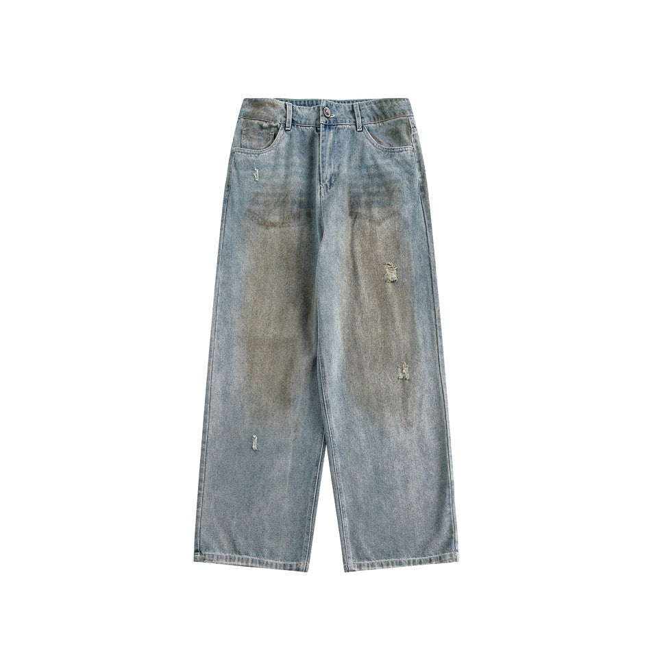 Front flat view of light blue washed wide-leg jeans with brownish fading and small distressed rips