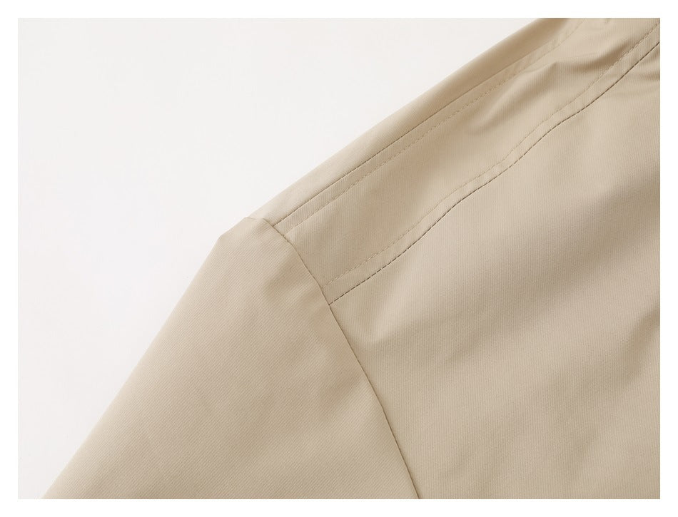 Close-up of beige jacket shoulder seams and sleeve construction.