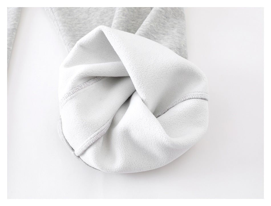 Close-up showing the soft white fleece lining inside a light gray sweatpant leg.