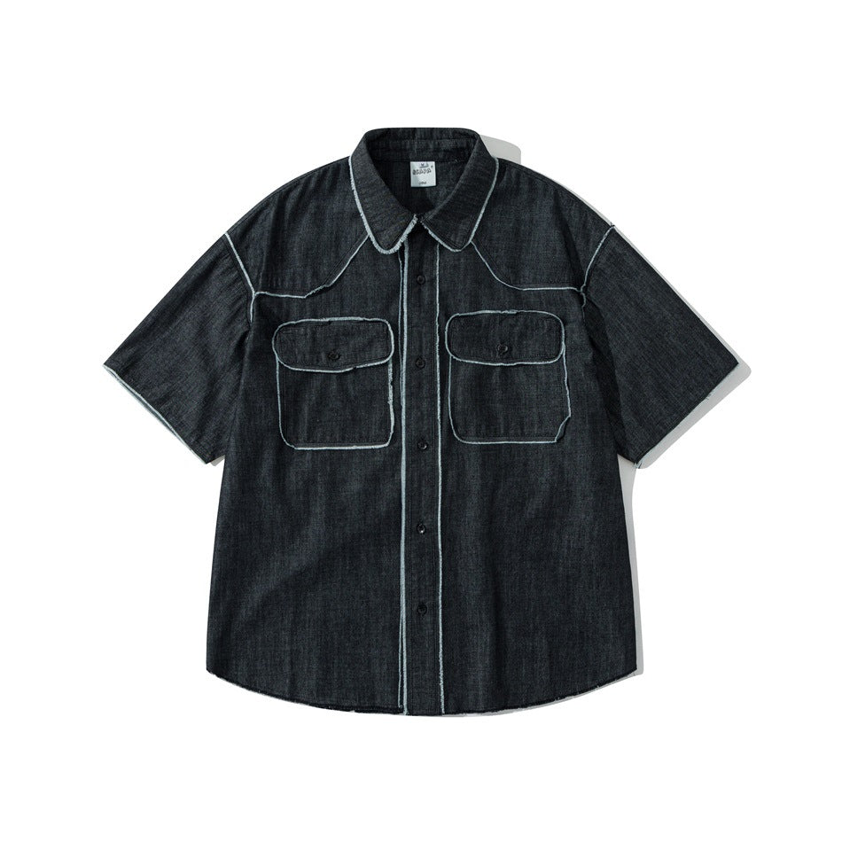Black washed short-sleeve denim shirt with two flap chest pockets and frayed light seam trim, flat front view