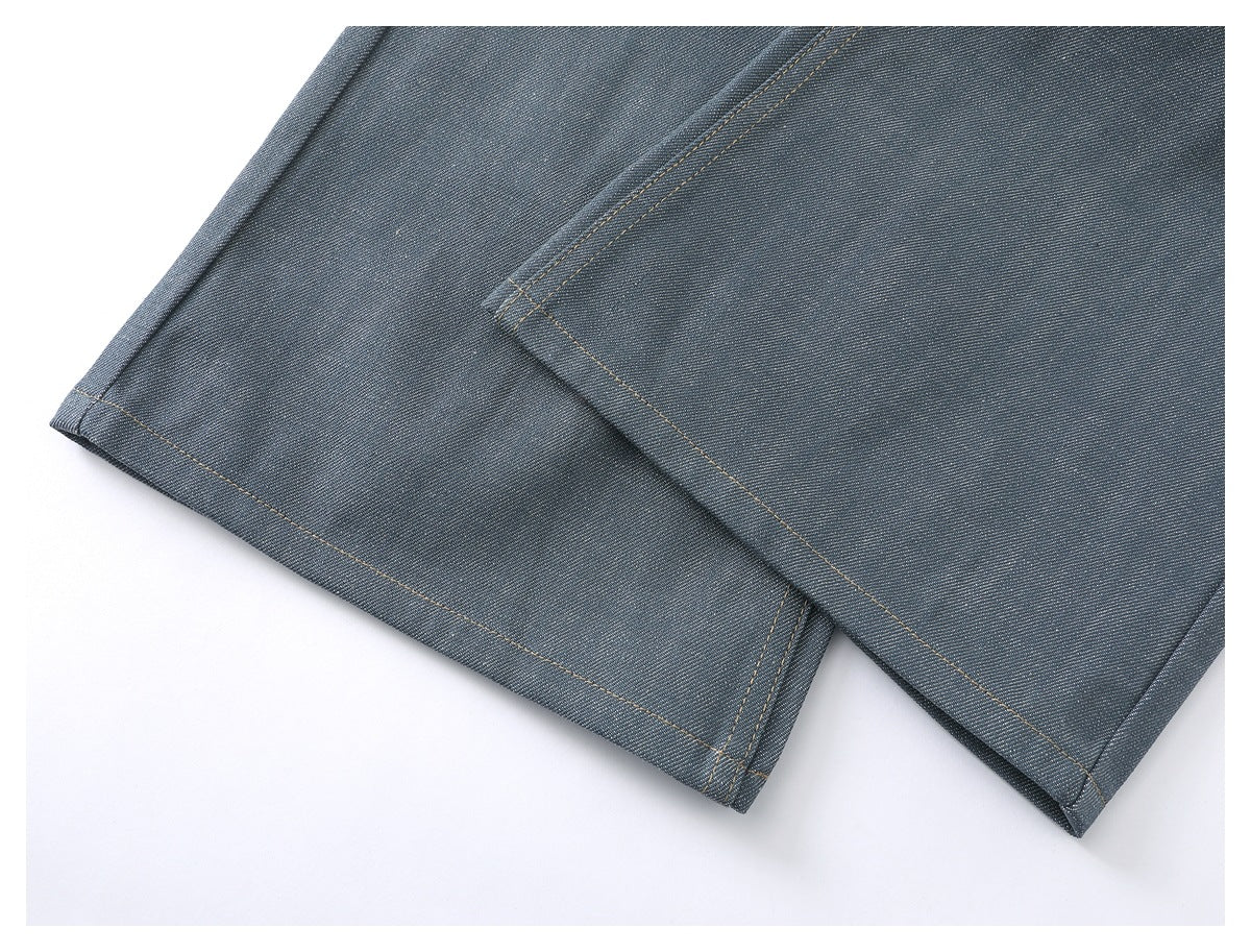 Close-up of the blue-gray trouser legs and stitched hems laid flat.