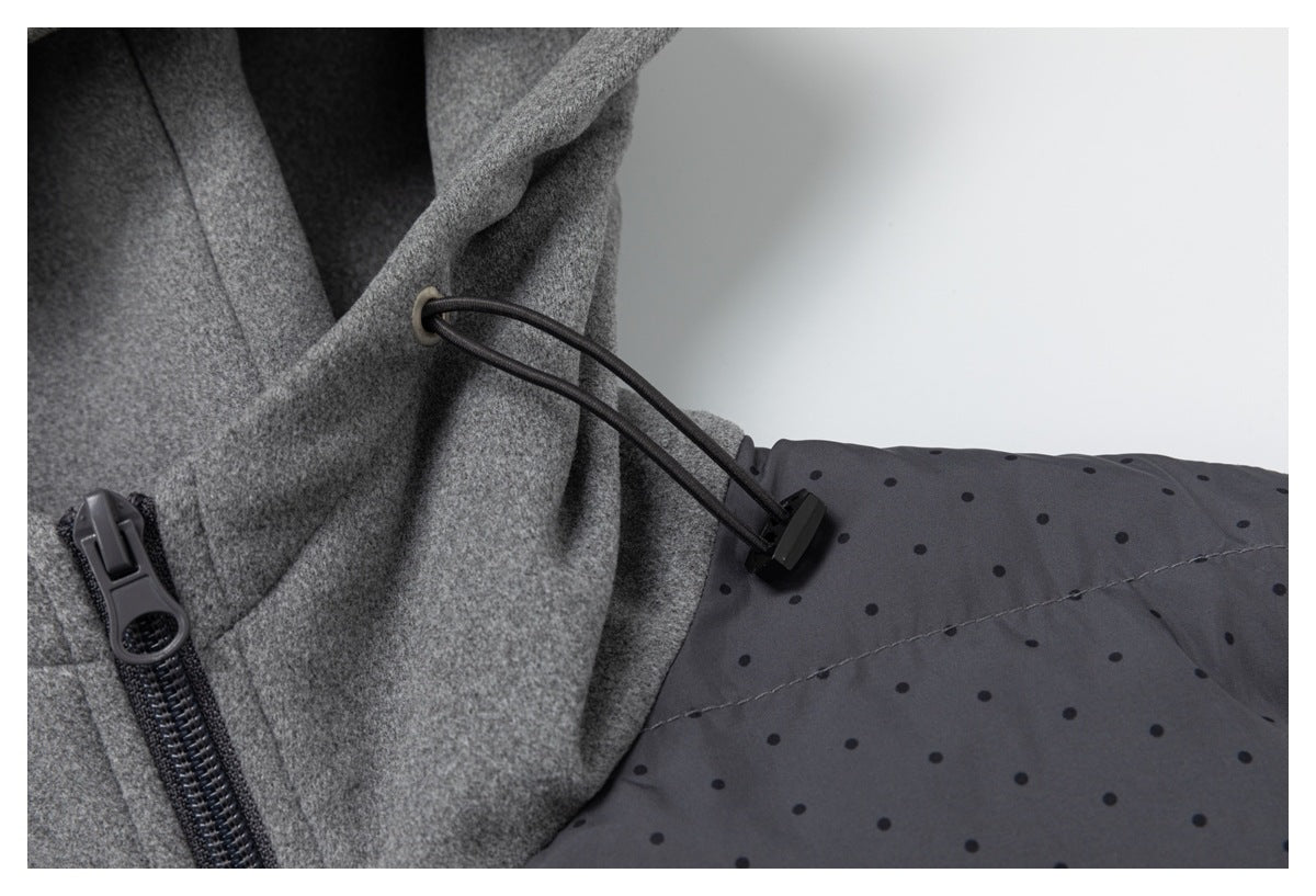 Close-up of the hood's black drawcord and toggle beside the front zipper and charcoal dotted jacket panel.