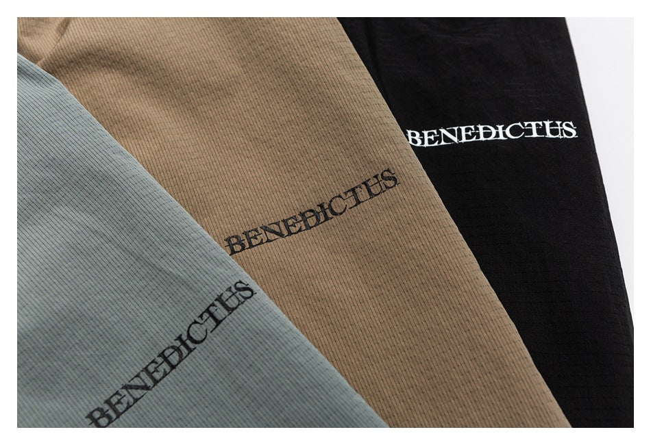 Close-up of three finely striped garment colorways in blue-gray, tan, and black, each with BENEDICTUS lettering.
